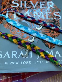 three bracelets on top of a book with the title silver frames by sarah d'ama