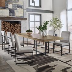 a dining table with six chairs and a potted plant in the middle of it