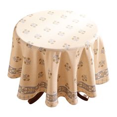 a round table covered with a beige and white floral design