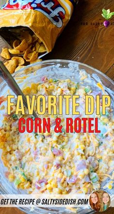 a bowl filled with corn and potato salad next to a bag of chips on the table