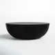 a black bowl sitting on top of a white table