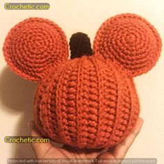 a crocheted mickey mouse hat is shown in the palm of someone's hand