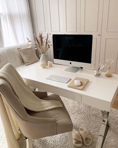 a white desk with a computer monitor and keyboard