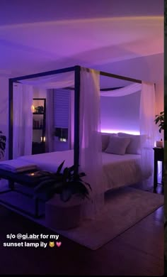 a bed with white sheets and purple lights in a room that is lit up at night