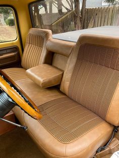 the interior of an old car with leather upholstered seats and wood trims