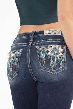 Mid-rise, dark-wash bootcut jeans- Embroidered Azteca dreamcatcher design- Leather appliqué, rhinestone, sequins and turquoise rivet accents- Embossed white leather Azteca embroidered Miss Me brand patch- 5-pocket design- Light fading Model is wearing size: 25Model Measurements:Height: 5'9"Bust: 34"Waist: 24"Hips: 34" Fabric Content: 66% Cotton, 14% Lyocell, 18% Polyester, 2% Elastane Care: Gentle machine wash with like colors in cold water. Tumble dry low. Style No. M9214B-D1068 Pure Western Jeans, Jean Collection, Western Show Shirts, Pocket Designs, Brown And Turquoise, Western Clothes, Dark Wash Bootcut Jeans, Cute Country Outfits, M Logo