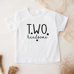 Two Handsome! Cute Toddler Shirt printed on the chest. Each item is handmade and beautifully packaged with lot's of love, care, and attention to detail. This toddler shirt is the perfect gift for a Big Brother, Family photo shoot, Baby Announcement and much more. Made with 100% cotton (solid colors) and cotton poly blend (heather colors)  for a soft fit. Each design is made with High Quality heat transfer vinyl and applied with a commercial heat press.  * S I Z I N G   &   M A T E R I A L S Brand: Bella Canvas 100%  cotton for solid colors and cotton poly blend for heather colors. Color: White, Black and Heather Mauve Sizing: 2T, 3T, 4T and 5T * P R O C E S S I N G   &   S H I P P I N G  T I M E S Once we receive your order, it takes one day to produce and 1-2 days to ship your order. Plea Cotton Tops With Name Print For Birthday Gift, Personalized Cotton Shirt As Gift, Unisex Cotton Birthday Shirt, Birthday Boy Shirt, Birthday Boy Shirts, Boy Shirt, Two Year Olds, Birthday Boy, Family Photoshoot