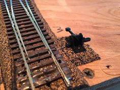 a close up of a train track on a wooden surface