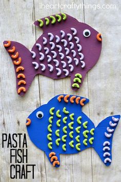 two colorful fish made out of paper on a wooden surface with text overlay that says pasta fish craft