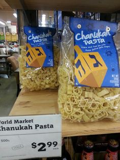 two packages of noodles are on display for sale in the store's department aisle