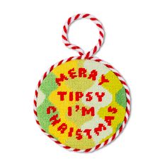 a round ornament with the words merry tipsy on it