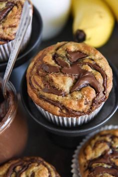 chocolate swirl muffins with bananas in the background