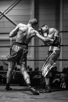 black and white photograph of two men boxing