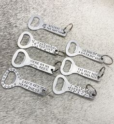 four metal keys with words on them sitting on top of a gray carpeted floor