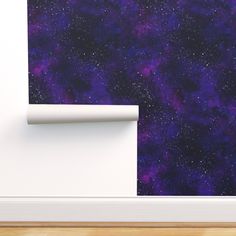 a space themed wallpaper with purple and blue stars