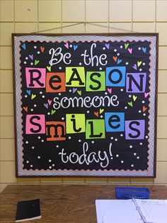 a bulletin board with the words be the reason someone smiles today written in multicolored letters