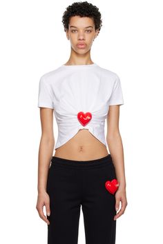 Moschino: White Inflatable Heart T-Shirt | SSENSE Cotton Graphic Tee With Appliqué Logo, Casual Cotton Tops With Appliqué Logo, White Short Sleeve Tops With Appliqué Logo, Spring Crew Neck Top With Heart Patch, Spring Heart Patch Crew Neck Top, White Crew Neck Top With Heart Patch, Casual Crew Neck T-shirt With Heart Patch, Sporty Cotton Top With Heart Graphic, White Cotton Top With Heart Patch