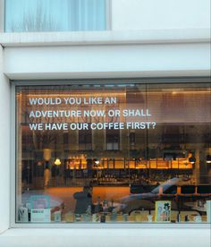 an advertisement on the window of a coffee shop that says, would you like an adventure now or snail? we have our coffee first?