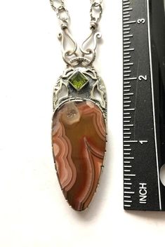 "Artisan Laguna Lace Agate pendant comes with 18 inches silver chain Hand-made Sterling Silver 925. Stones used: Laguna Lace Agate, Peridot. Height -2 1/2\" (with bail), Width - 15/16\" Height - 62mm, width-23mm Unique Handcrafted One-of a-kind Design Pendant. Each Piece of Jewelry in my Collection is Absolutely One of a Kind! When you start wearing a piece of my jewelry you will fall in love with it more and more each day and feel that good Energy and Love that I pass into it while creating thi Luxury Artisan Agate Jewelry, Amber Gemstone, Amber Ring, Mismatched Earrings, Unique Gemstones, Good Energy, Agate Pendant, Lace Agate, My Collection