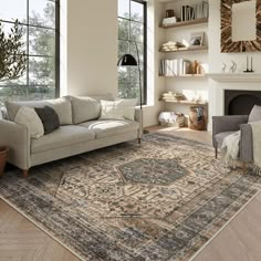 a living room filled with furniture and a large rug on top of a hard wood floor