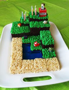 a cake made to look like a farm scene on a white plate with green grass