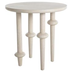 a white table with three wooden poles on the bottom and one leg in the middle