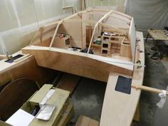 a wooden boat being built in a workshop