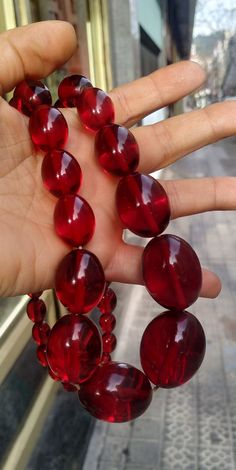 "Welcome! Gorgeous vintage cherry juice bakelite graduated bead Necklace measuring 25.19\" inches long (64 cm). The necklace is strung nylon string and has the original clasp. Beautiful Color! Excelent Condition! Thanks for stopping by!!IMPORTANT: Due to the delicate situation We're all going through, and in order to keep the safety of courier workers too, all orders will be dispatched when alert sanitary finished. You can purchased or reserve items like always. Thanks so much for your understan Plastic Accessories, 1970s Jewelry, Palm Leaf Plates, Vintage Jewelry Repurposed, Bakelite Bracelets, Bakelite Jewelry, Vintage Cherry, Cherry Juice, Indian Jewelry Sets