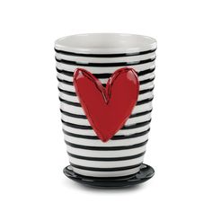 a black and white striped cup with a red heart on it