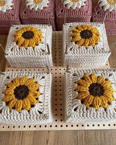 four square crocheted sunflowers are on display