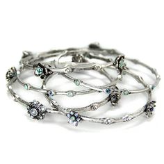 Iconic 1950s retro glamour-- a set of five bangles, Featuring stations of different little flowers. Delicate and sculptural, feminine and fun to wear. Inner diameter of each bangle is 8" This is suitable for those who wear a 6-1/2" to 8" bracelet. Made in our Los Angeles studio. This trending, sophisticated style of the 21st century is based on the best of our vintage past. Made in our Los Angeles studio. Ready to gift. Free ship. Order online or 800-935-1935 Stackable Vintage Bangle, 1950s Retro, Lovers Bracelet, Slide Bracelet, Message Bracelet, Jewelry Cleaning Solution, Bangle Bracelet Set, Stacked Bangles, Stackable Bracelets