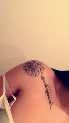 a woman with a sunflower tattoo on her shoulder and the words i love you