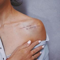 a woman with her arm wrapped around the shoulder has a tattoo that reads, we have to be happy