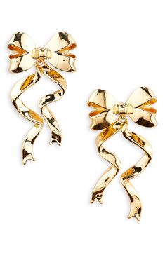 Show off sweet shine with bow earrings suspending twirly ribbon drops finished in glossy goldtone plate. 2" drop; 1" width Post back Goldtone plate or goldtone plate/glass Imported Christmas Bow Earrings, Gold Jewelry For Holiday Party, Holiday Party Gold Jewelry, Gold Holiday Drop Earrings, Elegant Gold Earrings For Holiday, Elegant Gold Earrings For The Holiday Season, Yellow Gold Jewelry With Decorative Bow For Party, Gold Ribbon Earrings For Party, Gold Holiday Earrings For Party