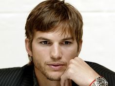 a close up of a person with a watch on his wrist and wearing a jacket