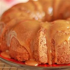 a bundt cake covered in caramel glaze on top of a red plate