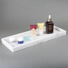 an assortment of skin care products on a marble tray