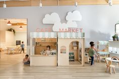 the children are playing in the play area at the cafe market, which is open for business