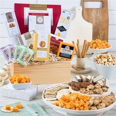 an assortment of cheeses, crackers and snacks