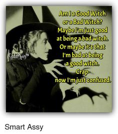 a woman wearing a witches hat and holding her hand out to the side with an evil witch