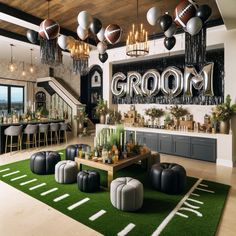 a football themed room with black and white decor, green rugs and stools