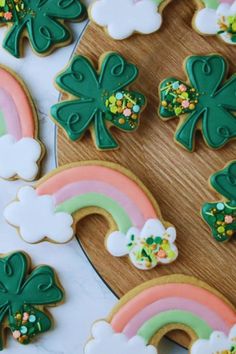 decorated cookies with shamrocks and rainbows on a table