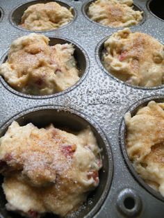 several muffin tins filled with some type of dessert or pie filling in them