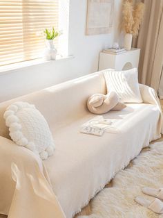 a white couch with pillows on top of it