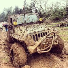 a jeep is stuck in the mud on a muddy road