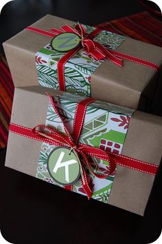 two presents wrapped in brown paper and tied with red ribbon