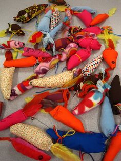 a pile of stuffed animals laying on top of a white floor