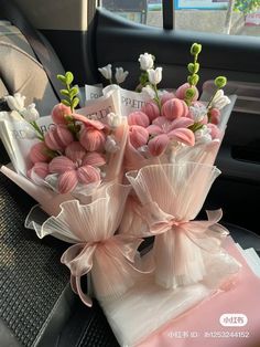 a bouquet of pink flowers sitting on top of a car seat