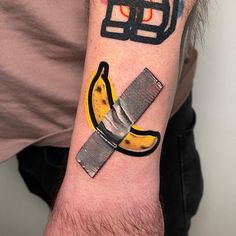 a man with a banana and knife tattoo on his arm