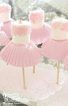 pink and white cupcakes with frosting on them